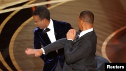 Will Smith hits at Chris Rock as Rock spoke on stage during the 94th Academy Awards in Hollywood, Los Angeles, California, U.S., March 27, 2022. (REUTERS/Brian Snyder)