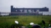 FILE - Tesla signage is seen at its factory in Shanghai, China, May 13, 2021.