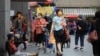 People wearing masks to protect against the coronavirus shop at a market in Keelung, Taiwan, April 28, 2022.