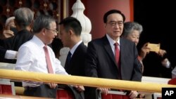Chen Quanguo, right, Communist Party secretary of China's Xinjiang Uighur Autonomous Region, stands on Tiananmen Gate with other leaders before a parade to commemorate the 70th anniversary of the founding of Communist China in Beijing, Tuesday, Oct…