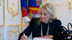 First lady Jill Biden signs a guest book during her visit with President of Slovakia Zuzana Caputova at the Presidential Palace in Bratislava, Slovakia, Monday, May 9, 2022. (AP Photo/Susan Walsh, Pool)