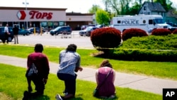 Sejumlah warga tampak berdoa di luar lokasi penembakan di sebuah supermarket di Buffalo, New York, pada 15 Mei 2022. (Foto: AP/Matt Rourke)