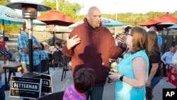 Pennsylvania Lt. Governor John Fetterman, who is running for the Democratic nomination for the U.S. Senate for Pennsylvania, greets supporters at a campaign stop, May 10, 2022, in Greensburg, Pa.