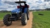 A farmer drives a tractor through a wheat farm in the Banket Zvimba district in Zimbabwe on May 4, 2022.