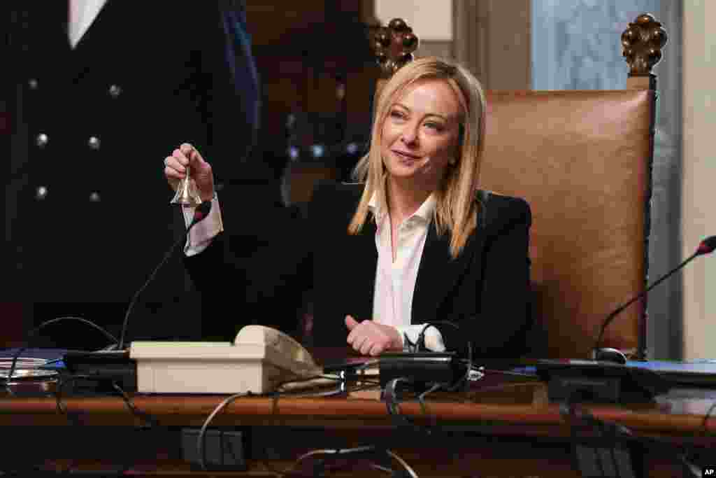 New Italian Premier Giorgia Meloni rings the cabinet minister bell during her first cabinet meeting at Chigi Palace Premier&#39;s office, in Rome.&nbsp;Giorgia Meloni, 45, whose political party with neo-fascist roots secured the most votes in Italy&#39;s national election last month, took office as the country&#39;s first far-right premier since the end of World War II. She is also the first woman to serve as premier.