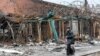 A man walks past a destroyed building in the southern port city of Mariupol, Ukraine, during Russia's invasion of Ukraine, April 14, 2022.