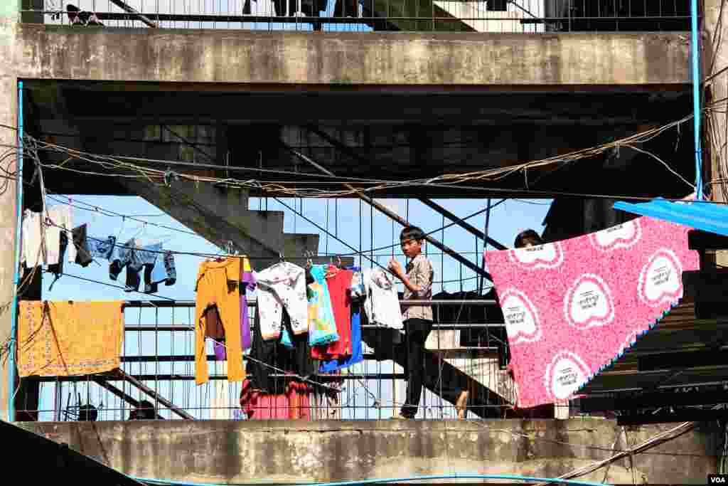 This stairway in the White Building is a common spot where residents dry their clothes and socialize, in Phnom Penh, Cambodia, Sept. 5, 2014. (Nov Povleakhena/VOA) 