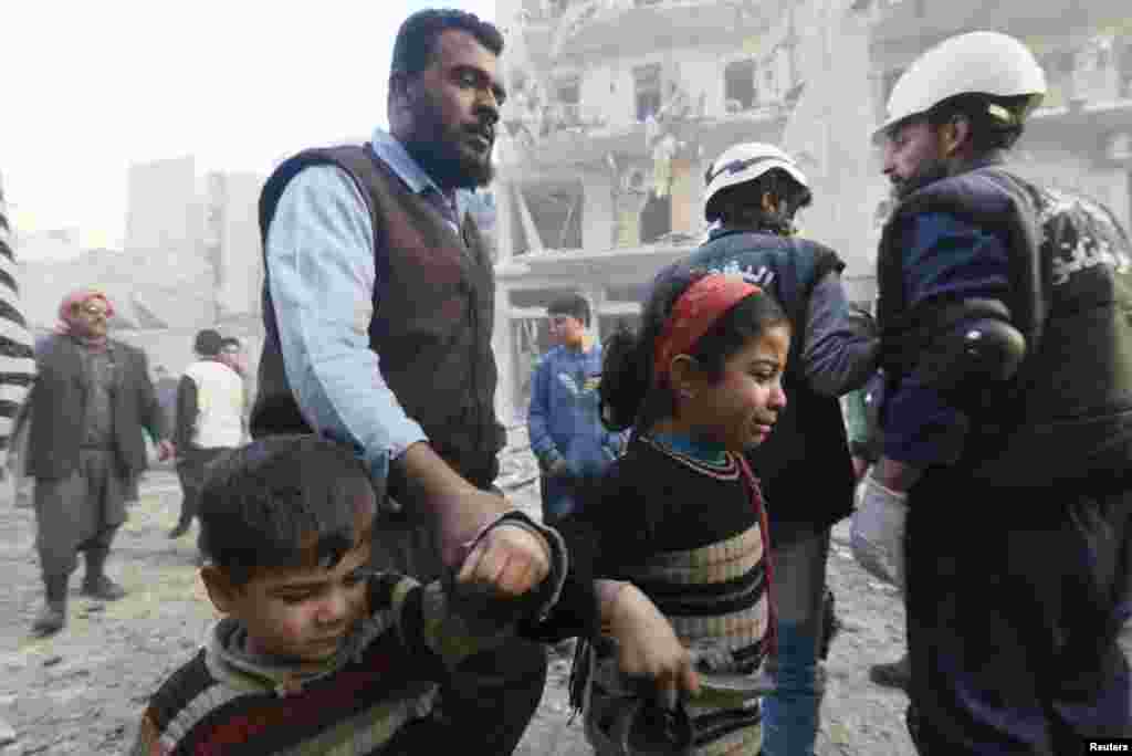 A young girl cries at a site hit by what activists said were barrel bombs dropped by government forces, Aleppo, Syria, Jan. 29, 2014. 
