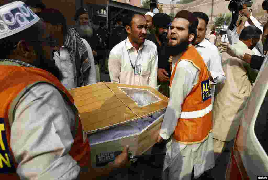 Relatives and rescue workers carry the coffin of a man, who was killed in a bomb blast, at a hospital in Peshawar, Oct. 7, 2013.