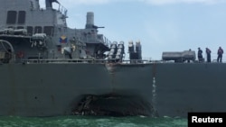FILE - The U.S. Navy guided-missile destroyer USS John S. McCain is seen after a collision, in Singapore waters Aug. 21, 2017. 
