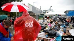 Striking French CGT labor union garbage collectors and sewer workers block access to a waste treatment plant to protest proposed labor reforms, in Ivry-sur-Seine, near Paris, France, May 31, 2016.