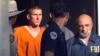 FILE - In this April 21, 1995 file photo, Timothy James McVeigh is lead out of the Noble County Courthouse by state and federal law enforcement officials in Perry, Okla., after being identified as a suspect in the bombing of the Oklahoma City Federal buil