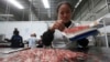 FILE: A woman works at a Japanese owned factory at the Phnom Penh Special Economic Zone (PPSEZ), on the outskirts of Phnom Penh, Dec. 17, 2014. 