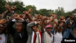 FILE - Demonstrators protest gesture during Irreecha, the thanksgiving festival of the Oromo people, in Bishoftu town, Oromia region, Ethiopia. More than 50 people were killed in the violence. 