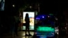 FILE - Sex workers stand in a largely shut-down red light area in Bangkok, Thailand, March 26, 2020.