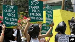 FILE: Protesters wear black plastic bags to symbolize injustice during a rally marking World Press Freedom Day, in Manila, Philippines.