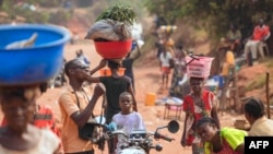 Vendeurs et passants se promènent dans une rue du quartier 3Z, où des affrontements entre les milices Kamuina Nsapu et les forces de sécurité ont eu lieu à Tshikapa, en République démocratique du Congo, le 28 juillet 2017.