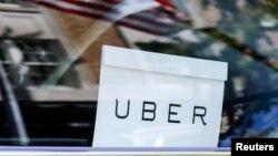 FILE - An Uber sign is seen in a car in New York, NY, U.S.