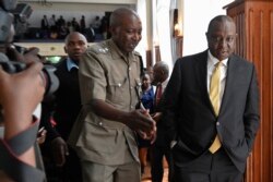 FILE - Kenya's Finance Minister Henry Rotich, right, arrives at the Milimani Law Courts in Nairobi, July 23, 2019.