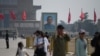Visitors walk near a portrait of Sun Yat-sen, the first provisional president of the Republic of China, in Beijing's Tiananmen Square on Labour Day, May 1, 2020.