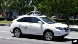 FILE - A Google self-driving car goes on a test drive near the Computer History Museum in Mountain View, Calif, May 14, 2014. 