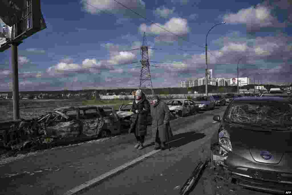 Residents evacuate the city of Irpin, north of Kyiv, March 10, 2022. Russian forces rolled their armored vehicles up to the northeastern edge of Kyiv, edging closer in their attempts to encircle the capital.