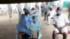 Harare Central Prison inmates line up to get vaccinated against COVID-19, in Harare, Zimbabwe, March 13, 2022. (Columbus Mavhunga/VOA)