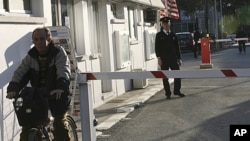 FILE - A Turkish Cypriot police officer, right, stands at the Ledra Palace border crossing, a passage between Greek and Turkish Cyprus.