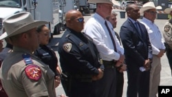 FILE - Uvalde School Police Chief Pete Arredondo, third from left, stands during a news conference outside of the Robb Elementary school in Uvalde, Texas, on May 26, 2022. This week, school officials fired Arrendondo for his handling of the fatal shooting rampage at the school.