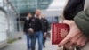 A person holds a Russian Passport at Vaalimaa border crossing point between Russia and Finland, in Vaalimaa, Finland, Sept. 23, 2022.