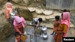 Rohingya refugees collect drinking water at the Shalbagan refugee camp in Teknaf, Bangladesh, March 5, 2019. 