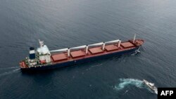 The cargo vessel Razoni is shown en route to Tripoli, Lebanon, along the Bosphorus Strait, Aug. 3, 2022, after being inspected. It's carrying the first grain exported from Ukraine since Moscow's invasion began, under a deal aimed at curbing a food crisis.