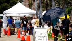 FILE - People line up at a monkeypox vaccination site in the U.S. state of California, July 28, 2022.