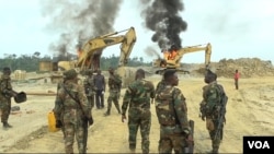 Soldiers Clash with civilians over burning escavator