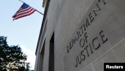 FILE - Signage is seen at the United States Department of Justice headquarters in Washington, Aug. 29, 2020. 