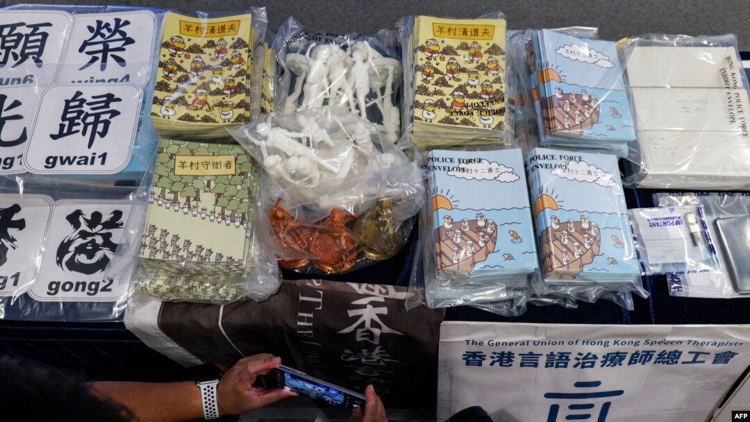 資料照片：2021年7月22日，在香港警方的新聞發布會上，媒體成員拍攝證據，包括試圖解釋香港民主運動的兒童書籍。此前，五人因出版這些書籍而被控煽動叛亂。