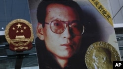 The picture of Chinese dissident Liu Xiaobo is carried by a protester demanding his release outside the China's Liaison Office in Hong Kong, Oct. 11, 2010.