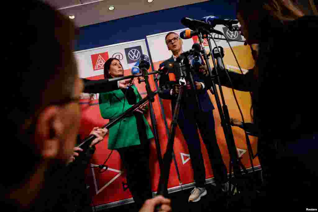 Daniela Cavallo, chairwoman of the general and group works council of Volkswagen AG, and Thorsten Groeger, district leader of Germany's metal worker union IG Metall, speak to the media before a second round of wage talks following VW's announcement to lay off thousands of employees and close down at least three VW plants, in Wolfsburg, Germany.