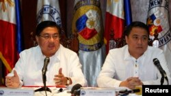 Philippine chief government negotiator Carlos Sorreta (L) speaks next to Pio Lorenzo Batino, Philippine Department of National Defense, Undersecretary for Legal and Legislative Affairs and Strategic Concerns during a news conference at the military headqu