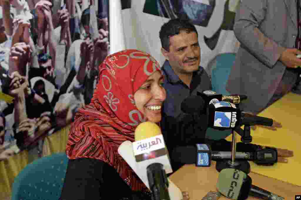 October 7, 2011: Yemeni activist Tawakkul Karman, next to husband, Mohammed Esmaeel al-Nehmy (R), speaks to journalists in Sanaa after the announcement that she had won the 2011 Nobel Peace Prize with Liberian President Ellen Johnson Sirleaf and Lib