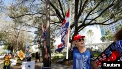 Former U.S. President Donald Trump supporter Kelly Fitzer waves a flag outside of the Conservative Political Action Conference (CPAC) in Orlando, Florida, U.S., Feb. 28, 2021.