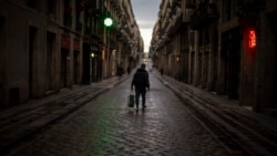 A man walks along an empty street in downtown Barcelona, Spain