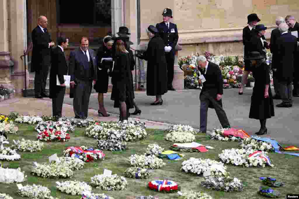 Carole Middleton, right, and Michael Middleton (second right) look at floral wreaths ahead of the Committal Service for Queen Elizabeth II in St. George's Chapel inside Windsor Castle, Sept.19, 2022.