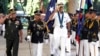 In this photo released by Public Affaires Office, Armed Forces of the Philippines, U.S. Adm. Samuel J. Locklear, third from left, commander of the U.S. Pacific Command, accompanied by Philippine Armed Forces Chief Gen. Gregorio Pio Catapang, left, salutes the colors during arrival honors, Oct. 14, 2014, at Camp Aguinaldo General Headquarters at suburban Quezon city northeast of Manila.