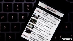 FILE - The Online Citizen general election iPhone app is seen on a phone in Singapore, April 26, 2011.
