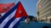 Cubans drive past the US embassy during a rally calling for the end of the US blockade against Cuba, in Havana, March 28, 2021 
