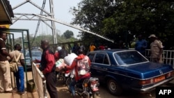 FILE - Security guards check vehicles leaving Nigeria for Cameroon at a border checkpoint in Mfum, in Cross Rivers State, southeast Nigeria, Feb. 1, 2018. Cameroon is securing borders with C.A.R and Nigeria amid renewed threats.