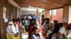 FILE - People wait to receive the AstraZeneca COVID-19 vaccine at Ndirande Health Centre in Blantyre, Malawi, March 29, 2021.