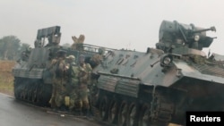 FILE: Soldiers stand beside military vehicles just outside Harare, Zimbabwe, Nov. 14,2017.