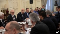 Greek foreign Minister Nikos Dendias, facing third left, takes part in a meeting with political party representatives on developments for the maritime boundary deal between Turkey and Libya in Athens, Dec. 10, 2019. 